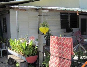 A yellow buoy recycled as a hanging planter