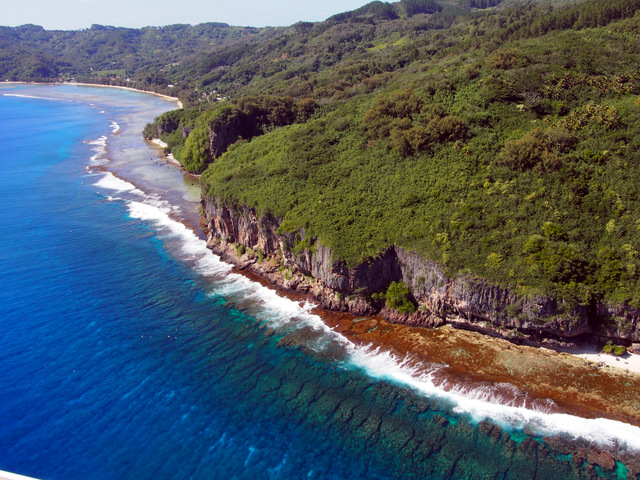Fringing reef directly off the coast from uplifted fossil reefs in Rurutu